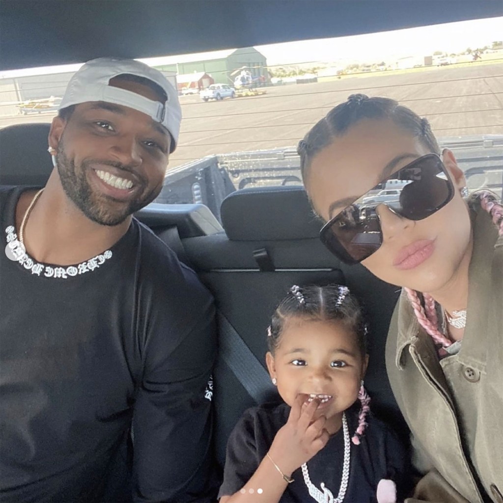 Tristan Thompson, Khloé Kardashian, and True Thompson in a car.