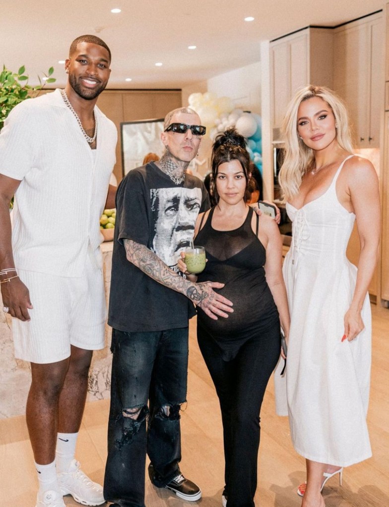 Tristan Thompson, Travis Barker, Kourtney Kardashian, and Khloe Kardashian posing for a photo.