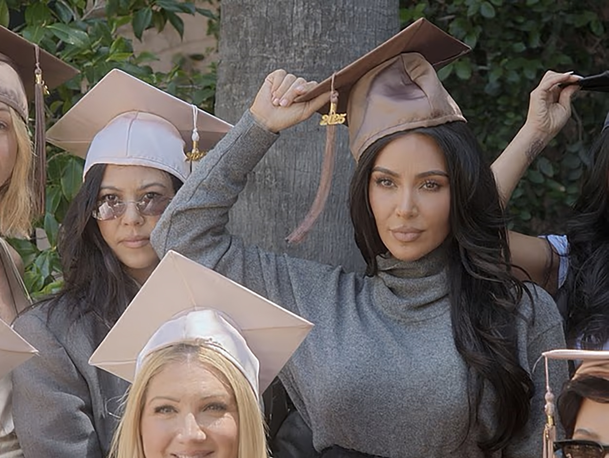Kim Kardashian wearing a brown graduation cap.