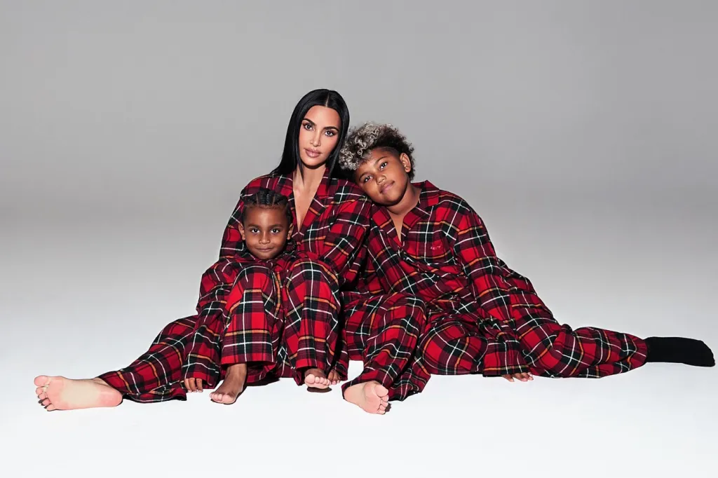 Kim Kardashian with Pslam and Saint in matching red plaid pajamas.