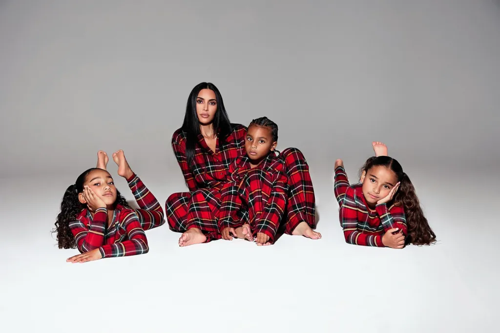 Kim Kardashian with daughter Chicago, son Psalm and her niece Dream in matching red plaid pajamas.