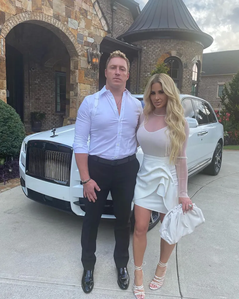 Kim Zolciak and Kroy Biermann in front of a white Rolls-Royce.