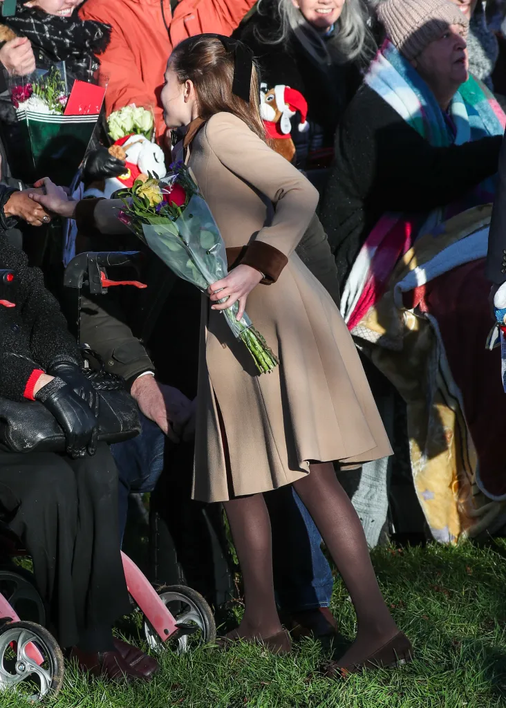 Princess Charlotte accepting flowers from a well-wisher.
