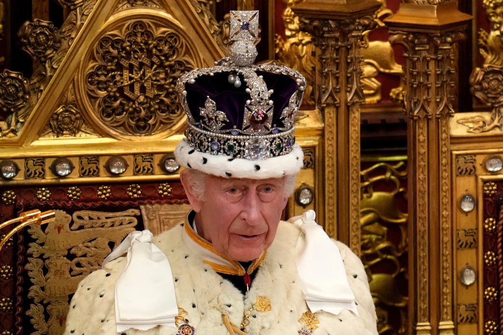 King Charles III wearing the Crown Jewels attends the State Opening of Parliament in the House of Lords.