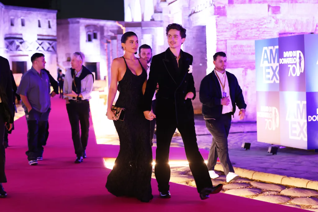 Kylie Jenner and Timothee Chalamet walking hand-in-hand on a red carpet at the 70th David Di Donatello awards.