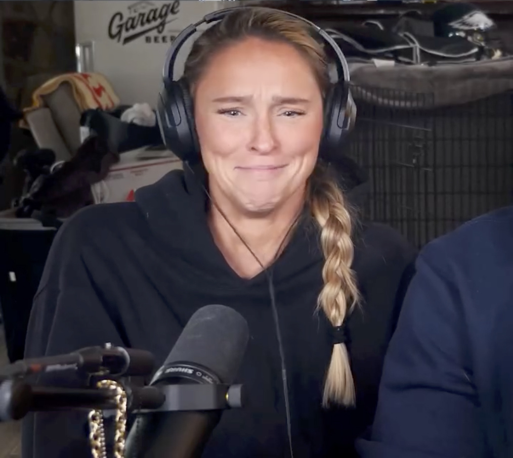 Kylie Kelce wearing headphones, laughing.