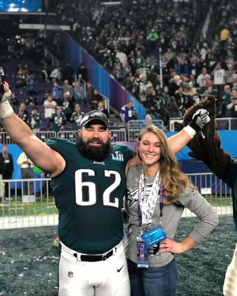 Jason and Kylie Kelce on a football field.