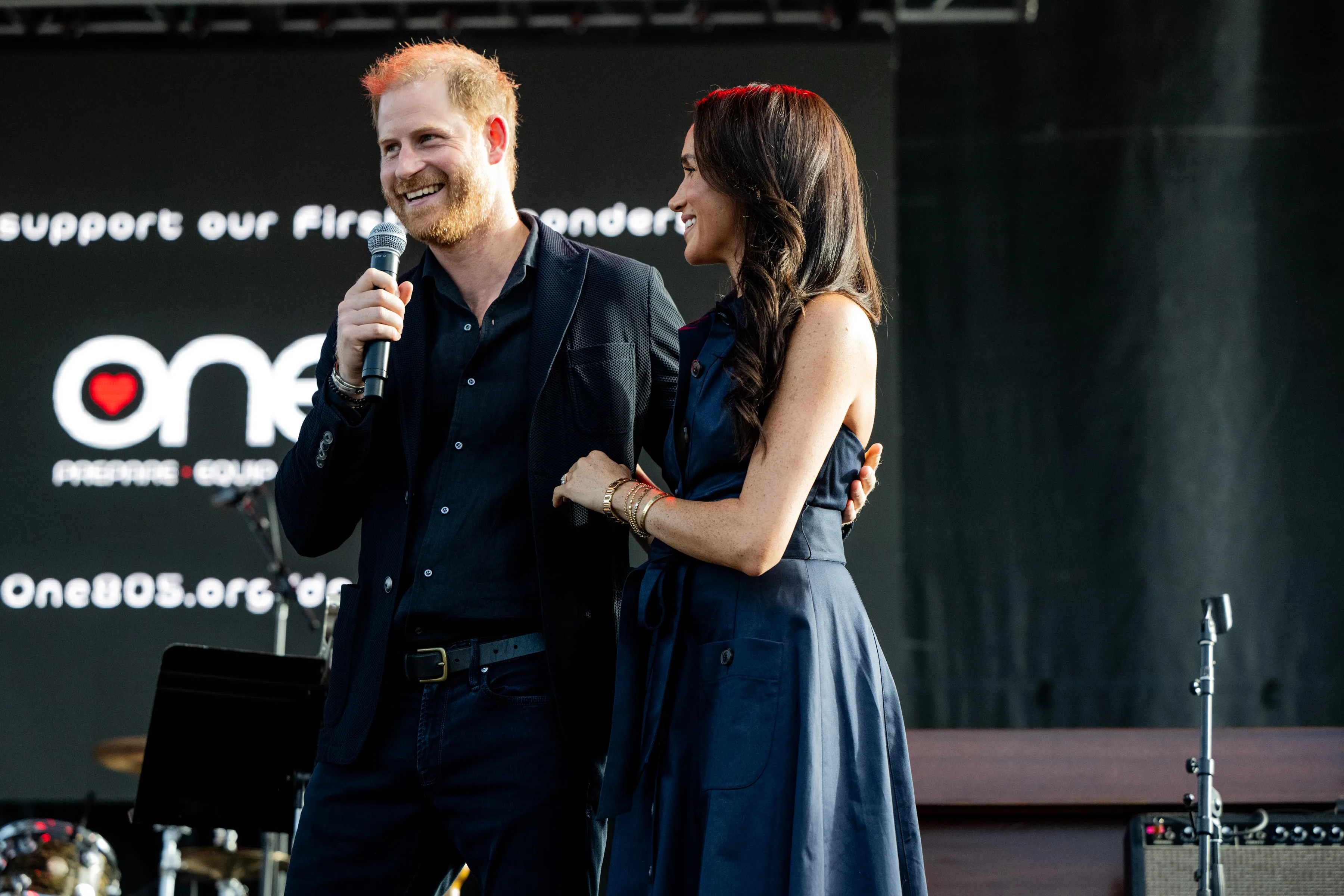 Prince Harry and Meghan Markle on stage at the One805LIVE! 2025 concert.