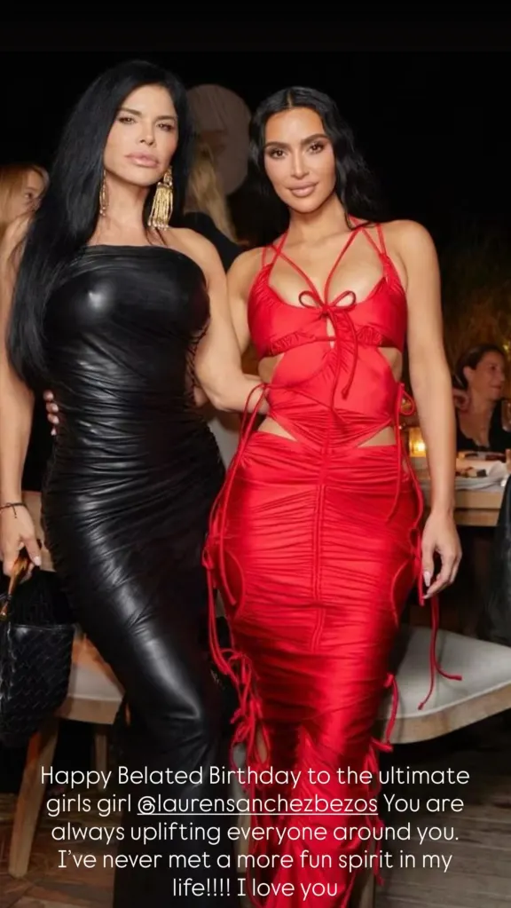 Lauren Sánchez in a black leather dress posing with Kim Kardashian in a red cutout dress.