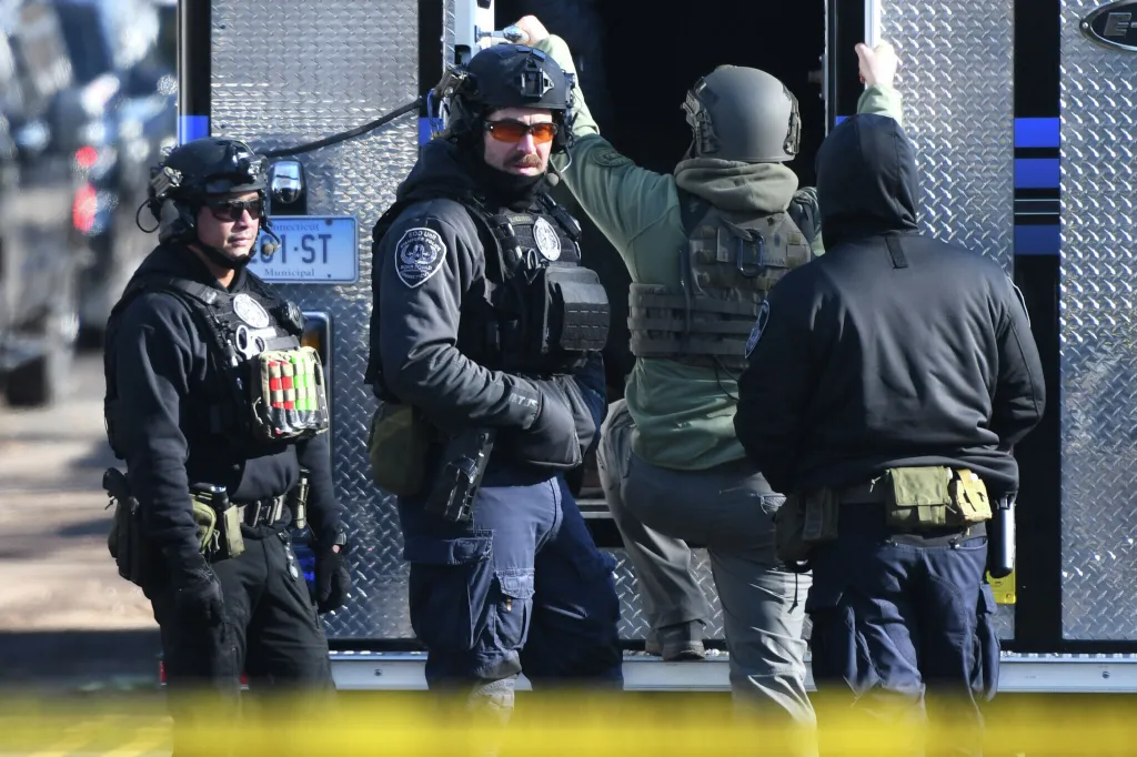 Police officers responding to a standoff where a decomposed body was found in Stamford, Connecticut.