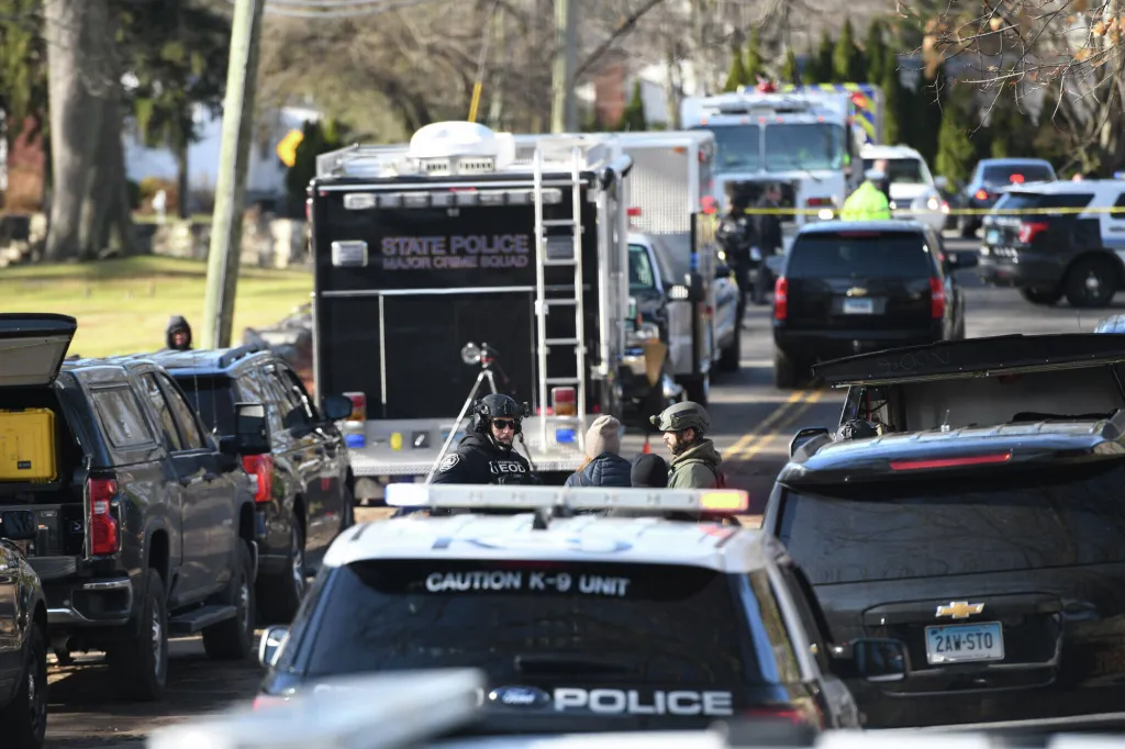 Law enforcement officers respond near a home where a man shot at officers and a decomposed body was later found in Stamford, Conn., Tuesday, Dec. 2, 2025.