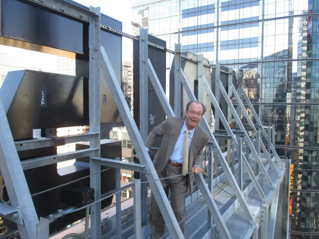Treb Heining, also known as the Confetti King, smiling among confetti machines.