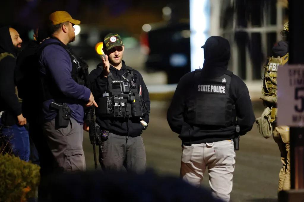 Law enforcement agents, including state police and the FBI, searching for the Brown University shooter in Salem, New Hampshire.