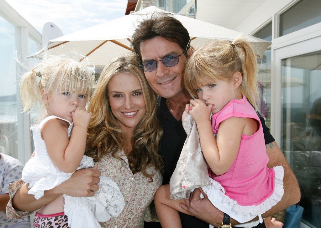Brooke Mueller, Charlie Sheen, and their daughters, Lola and Sam Sheen, attending a benefit event.