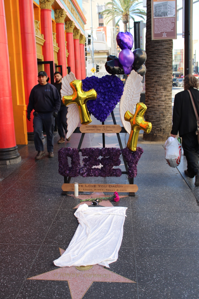 A tribute to Ozzy Osbourne at his Walk of Fame star, with balloons, flowers, and a sign from Sharon and his children.