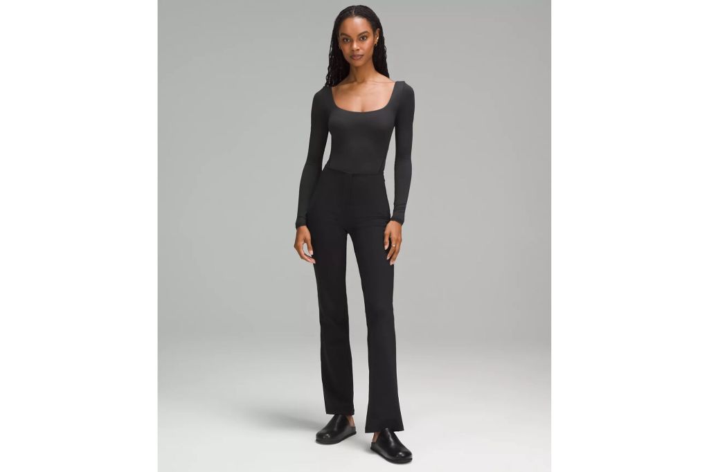 A woman wearing a bodysuit and pants.