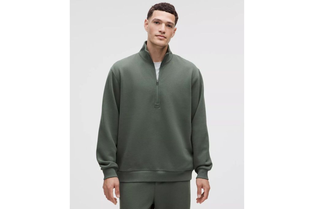 A man in a zip up sweatshirt.