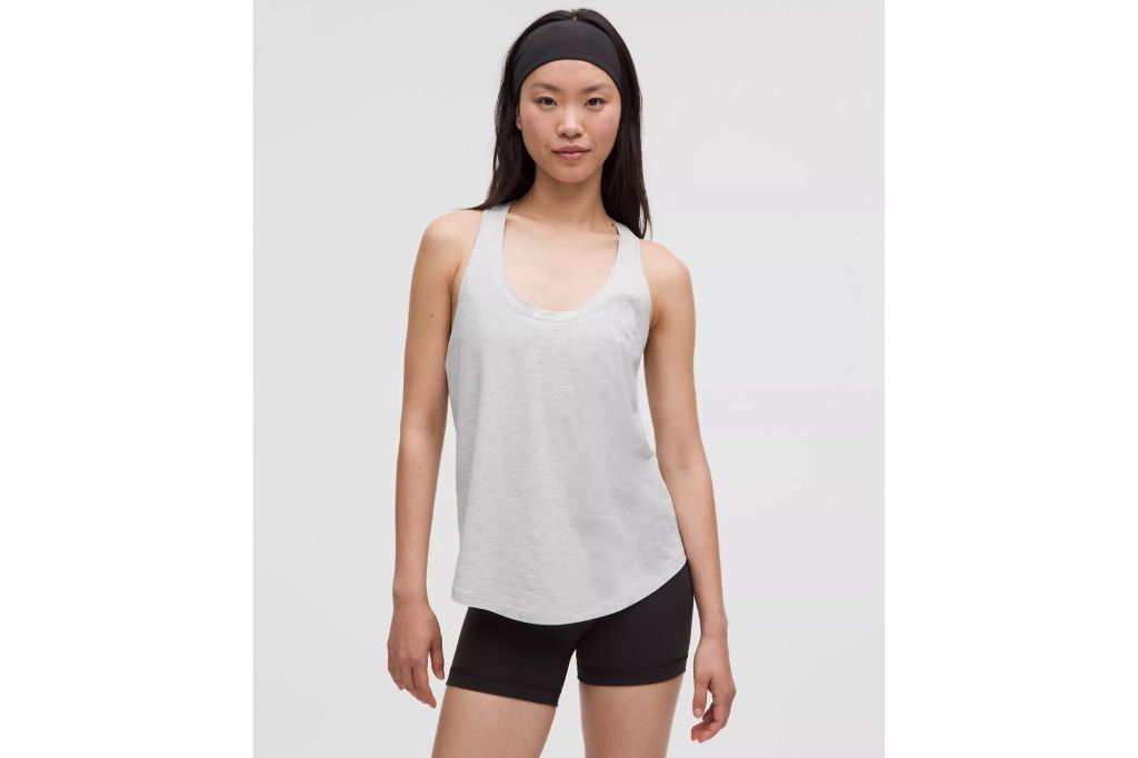 A woman in a tank and biker shorts.