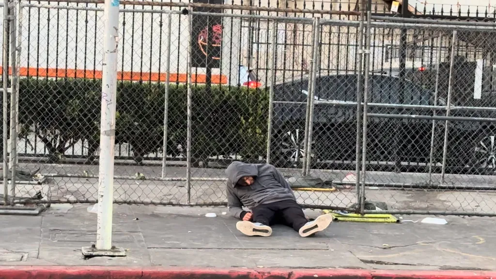 Homeless person on the ground in MacArthur Park.