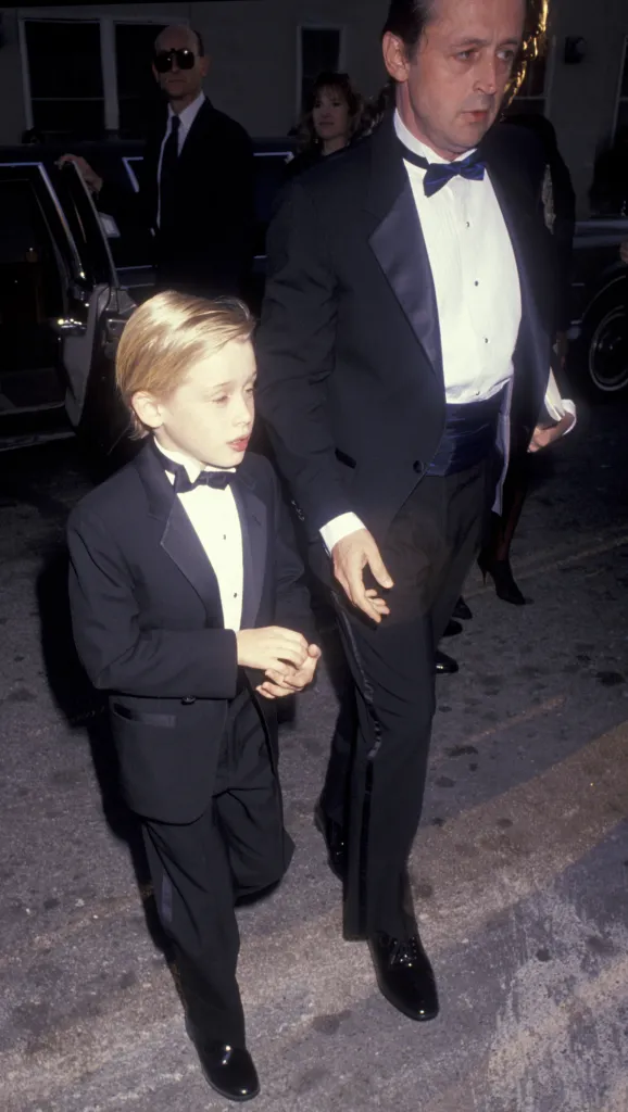 Macaulay Culkin and his father Kit Culkin walking into the 17th Annual People's Choice Awards.