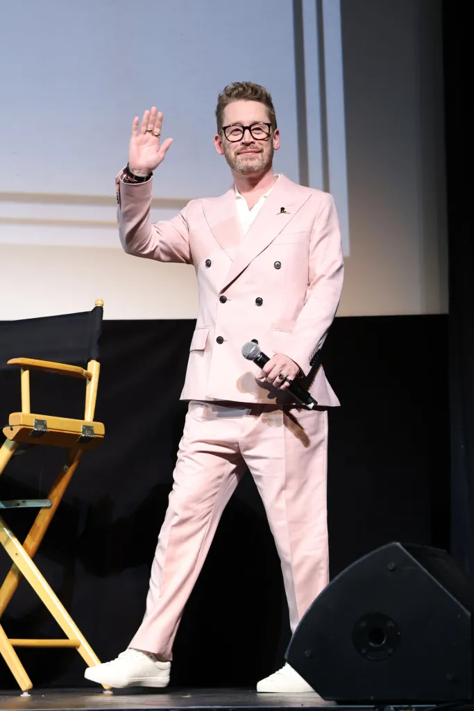 Macaulay Culkin speaking onstage at 