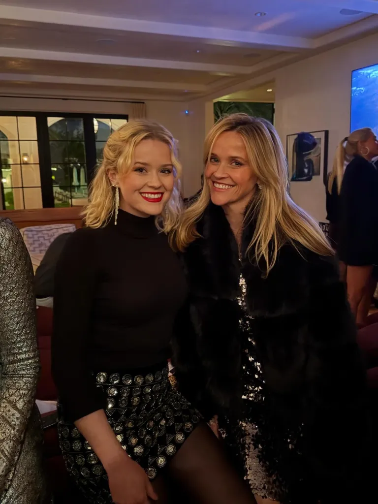 Ava Phillippe and Reese Witherspoon smiling together.