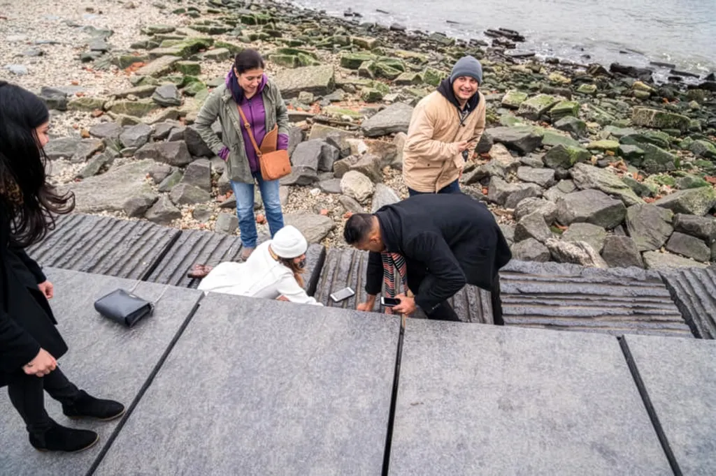A group of people looking for a dropped engagement ring in Brooklyn Bridge Park.