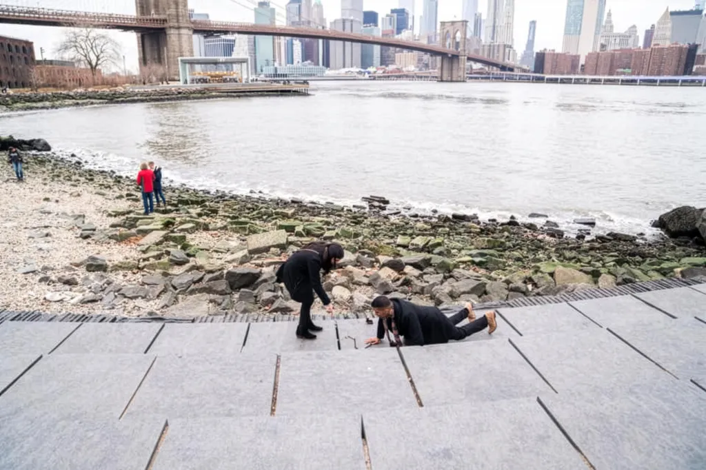 Man dropping the ring in Brooklyn bridge park.