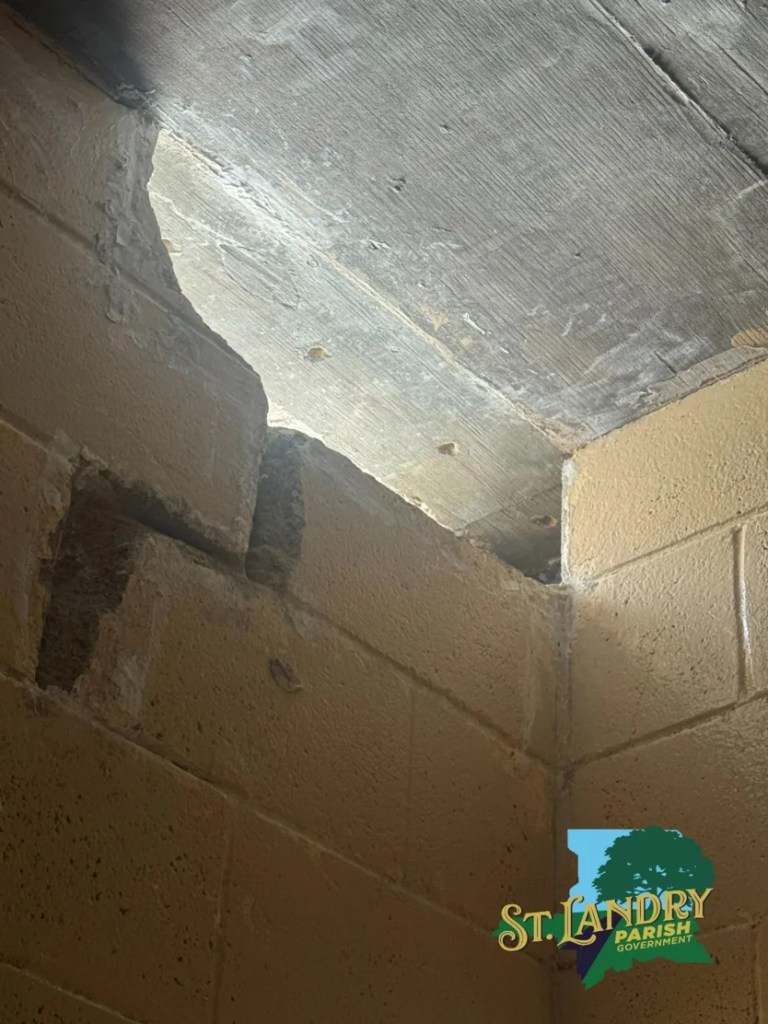 Damaged prison wall showing a hole that inmates likely used to escape.