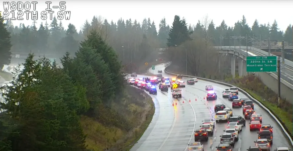 Traffic jam on I-5 at 212th Street SW due to an incident involving several police cars with flashing lights.