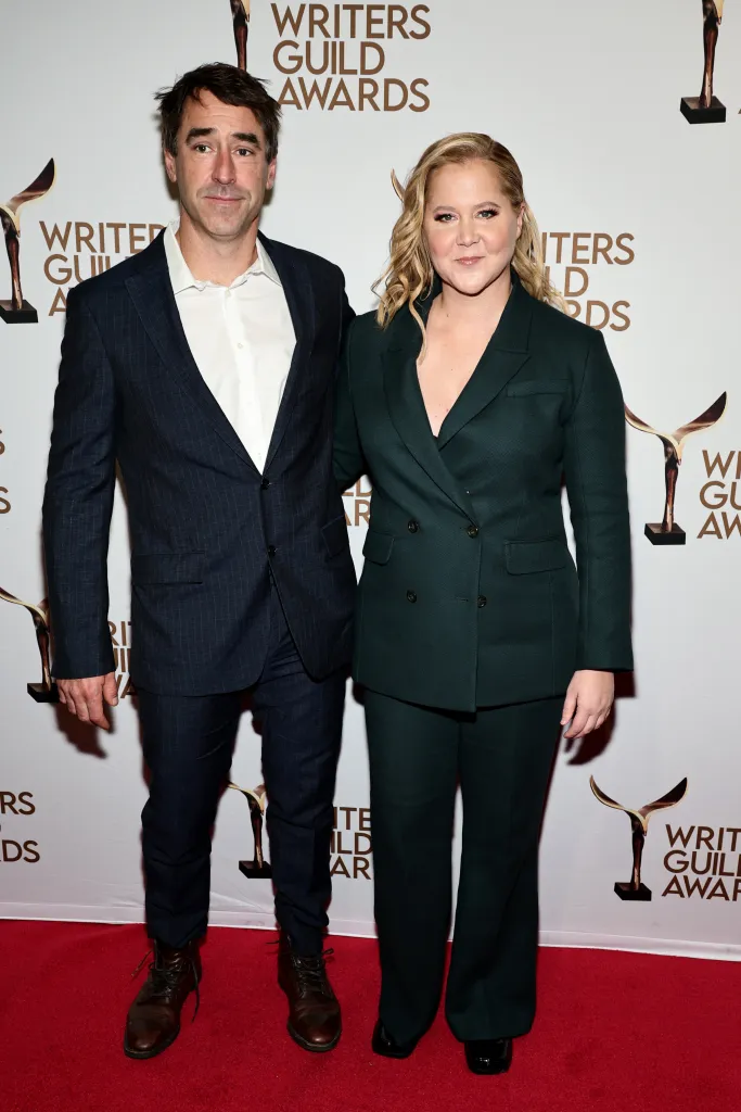 Chris Fischer and Amy Schumer posing at the Writers Guild Awards.