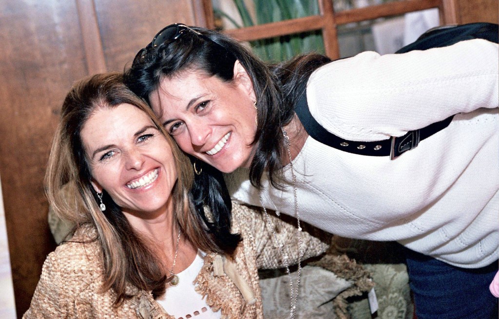 Maria Shriver and Michele Reiner smiling during a book signing event.
