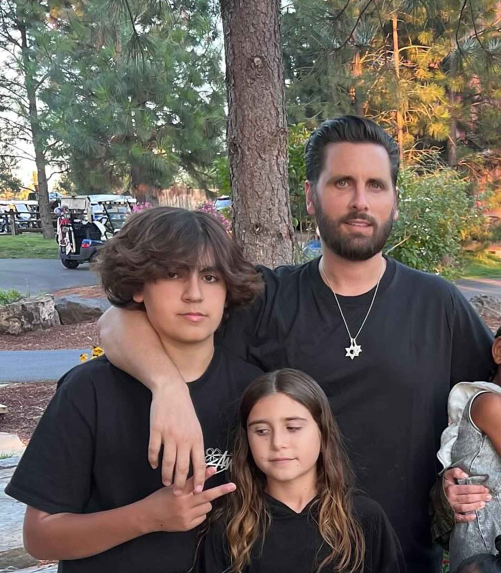 Mason Disick, sister Penelope, and father Scott Disick pose for a family photo
