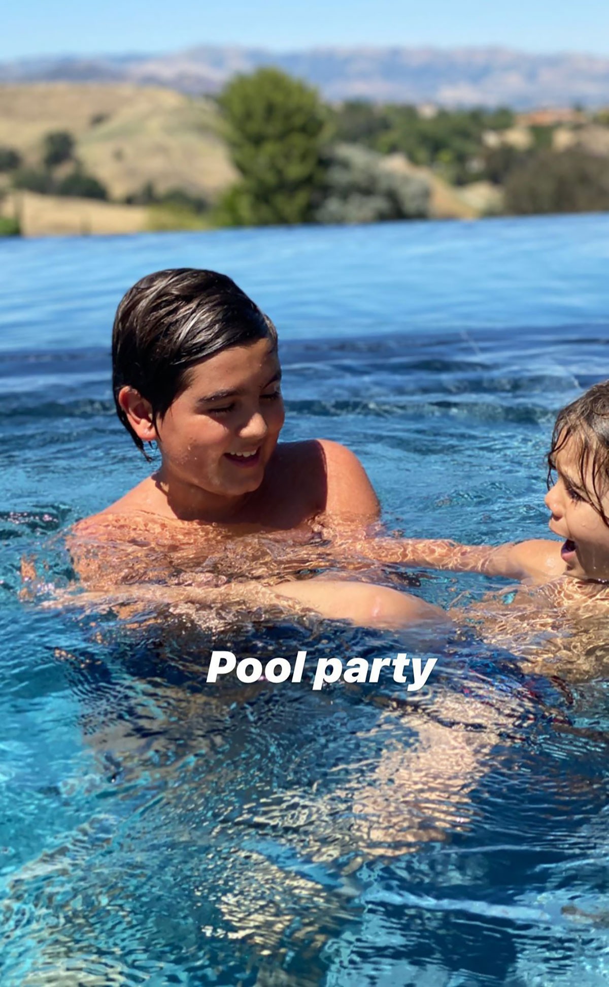 Mason Disick horses around with little brother Reign in the pool