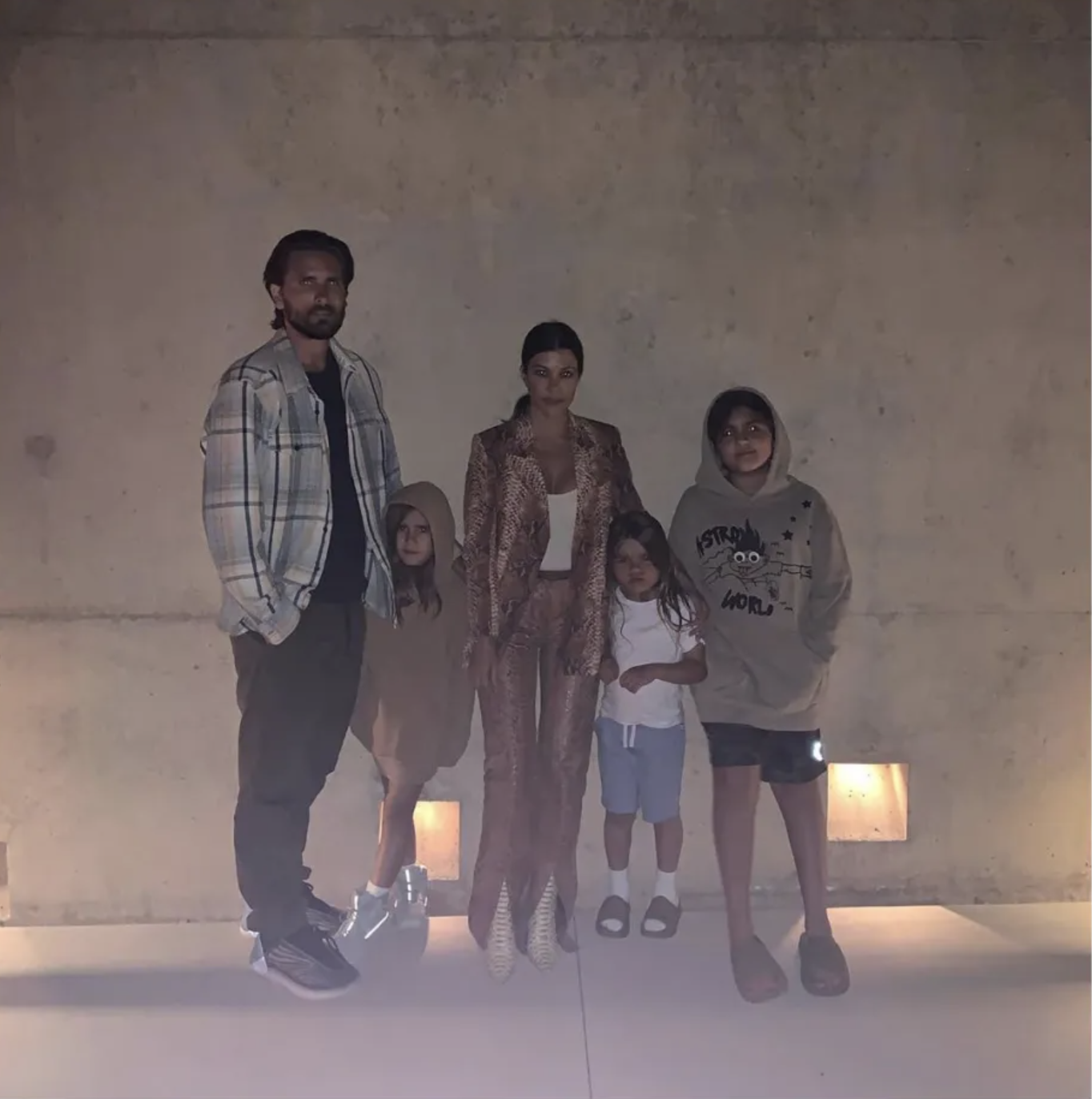 Scott disick, Penelope Disick, Kourtney Kardashian, Reign Disick, and Mason Disick pose for a family photo. 