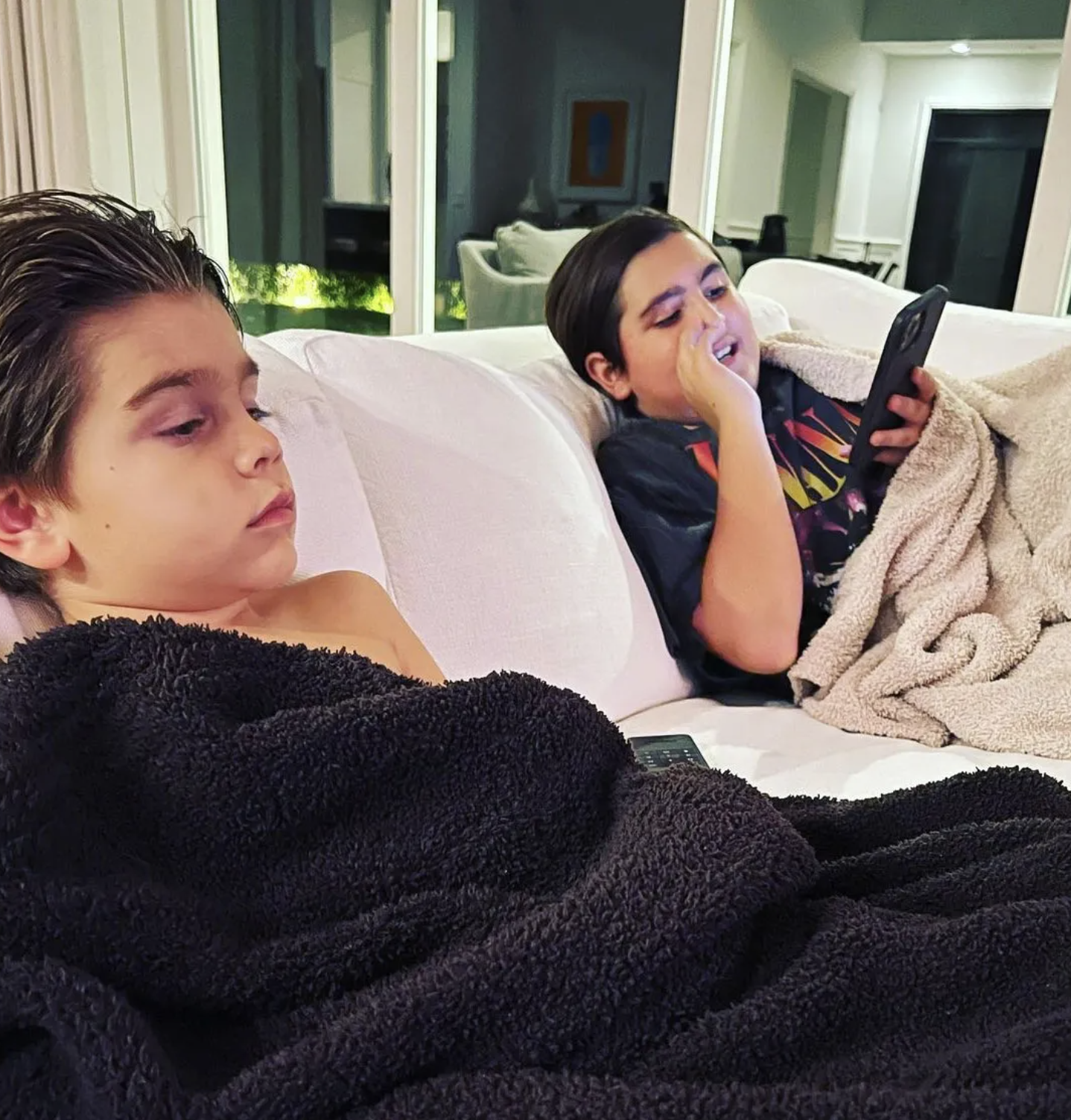 Mason and Reign disick hang out on the couch at home. 