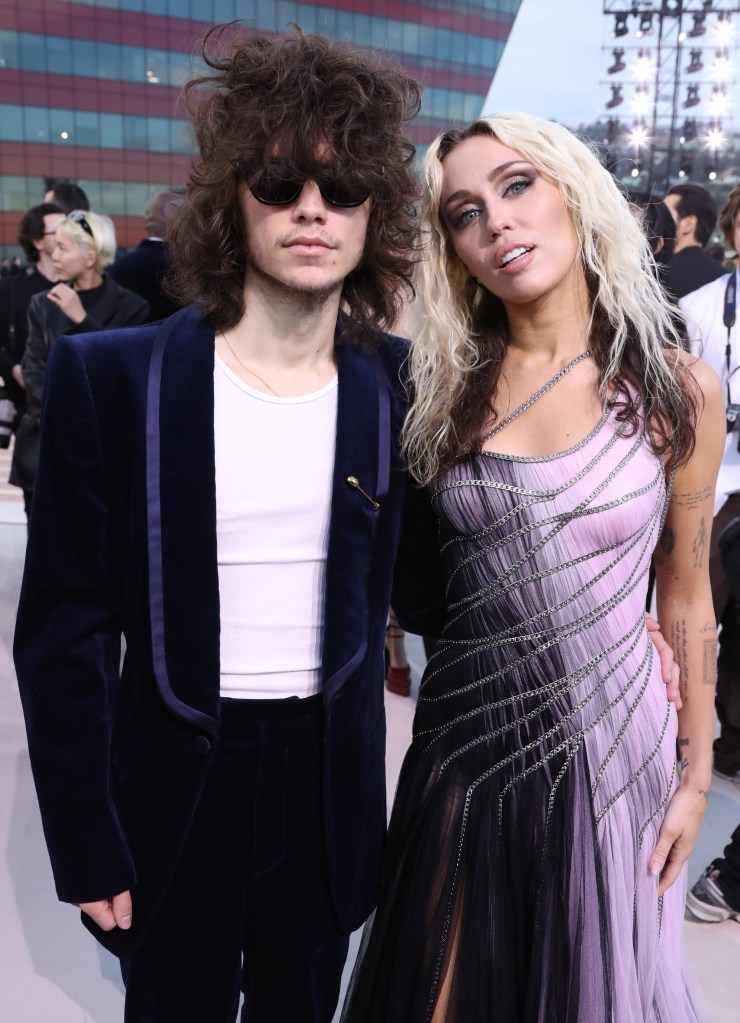 Maxx Morando and Miley Cyrus at the Versace show.