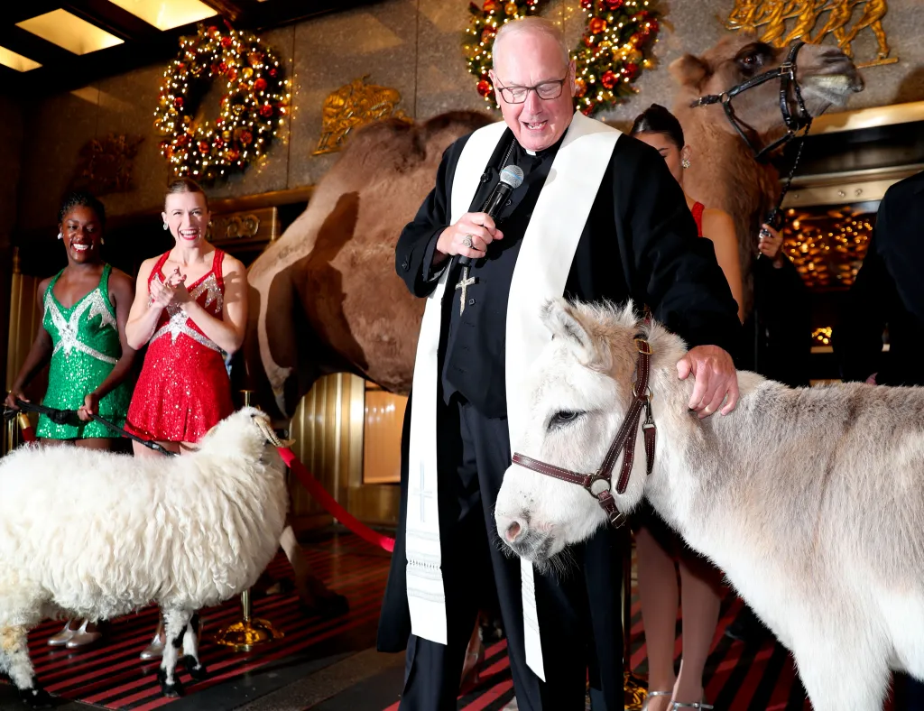 Cardinal Dolan blessing animals and Rockettes at Radio City.