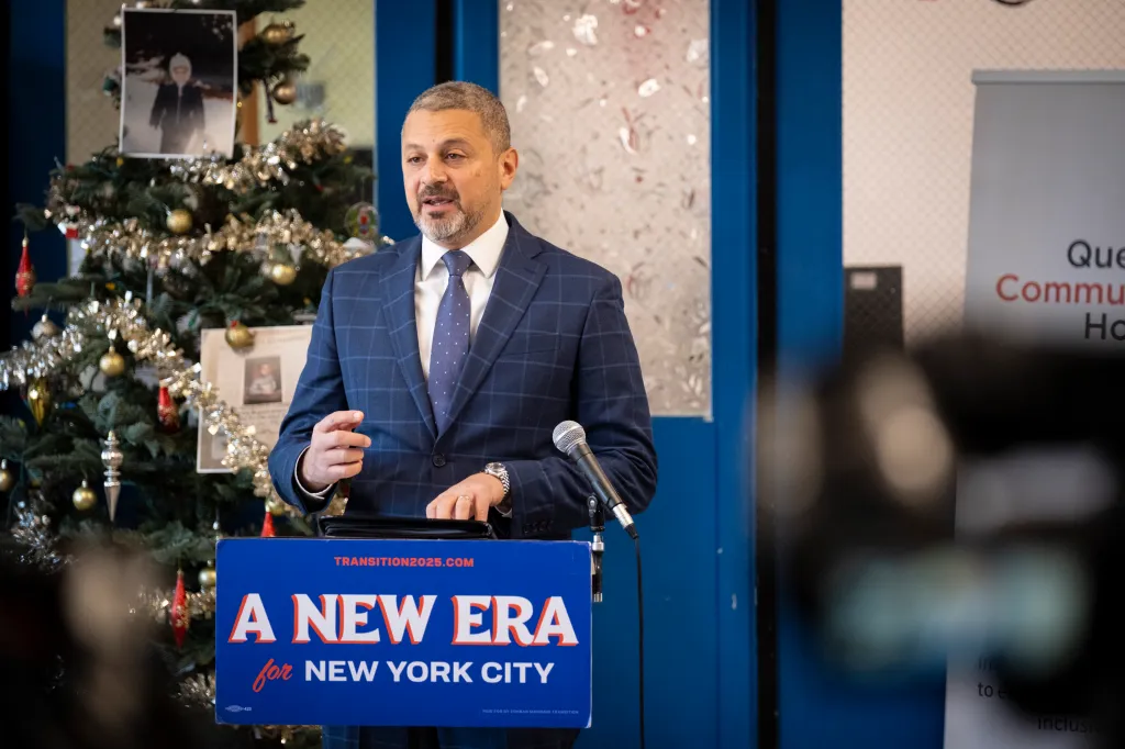 Mayor-elect Mamdani speaks at a podium with the text 