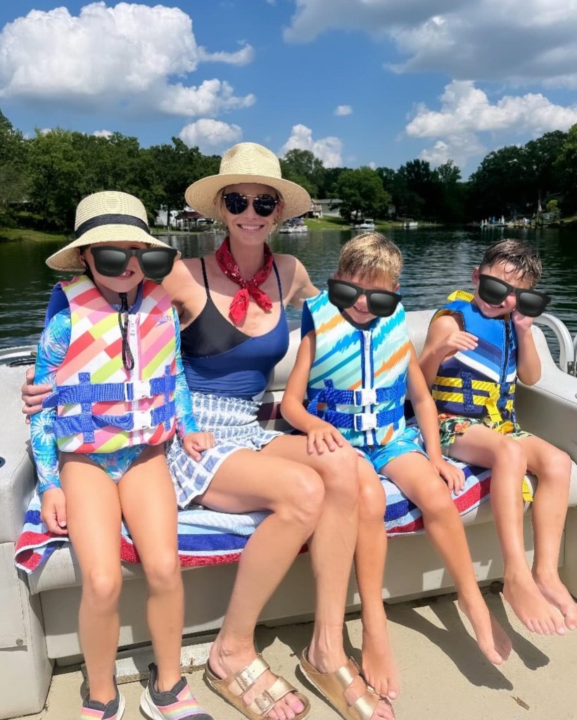 Meghan King with her three children on a boat.