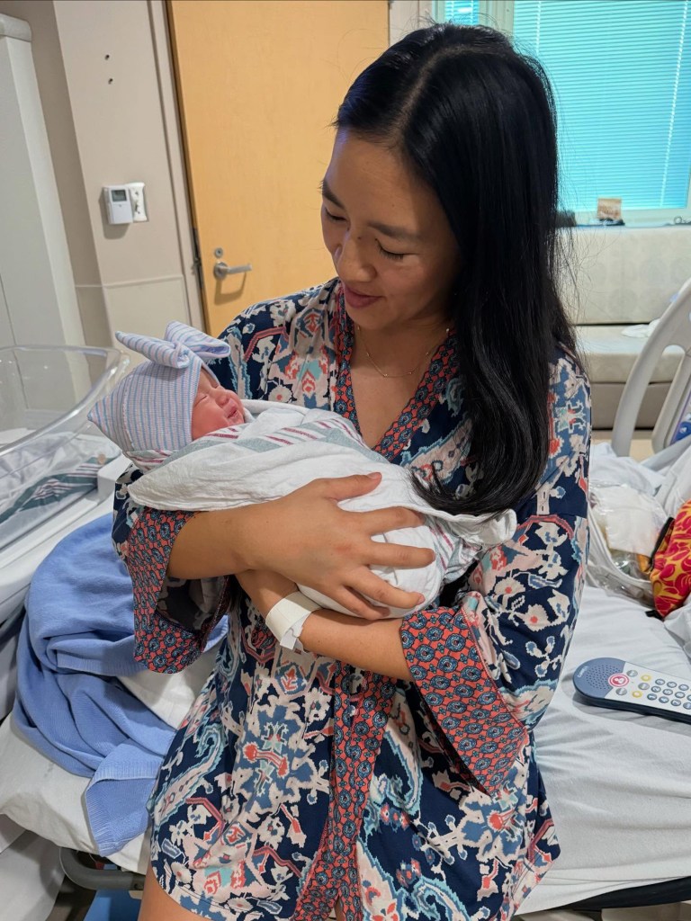 Michelle Kwan cradling her newborn baby.