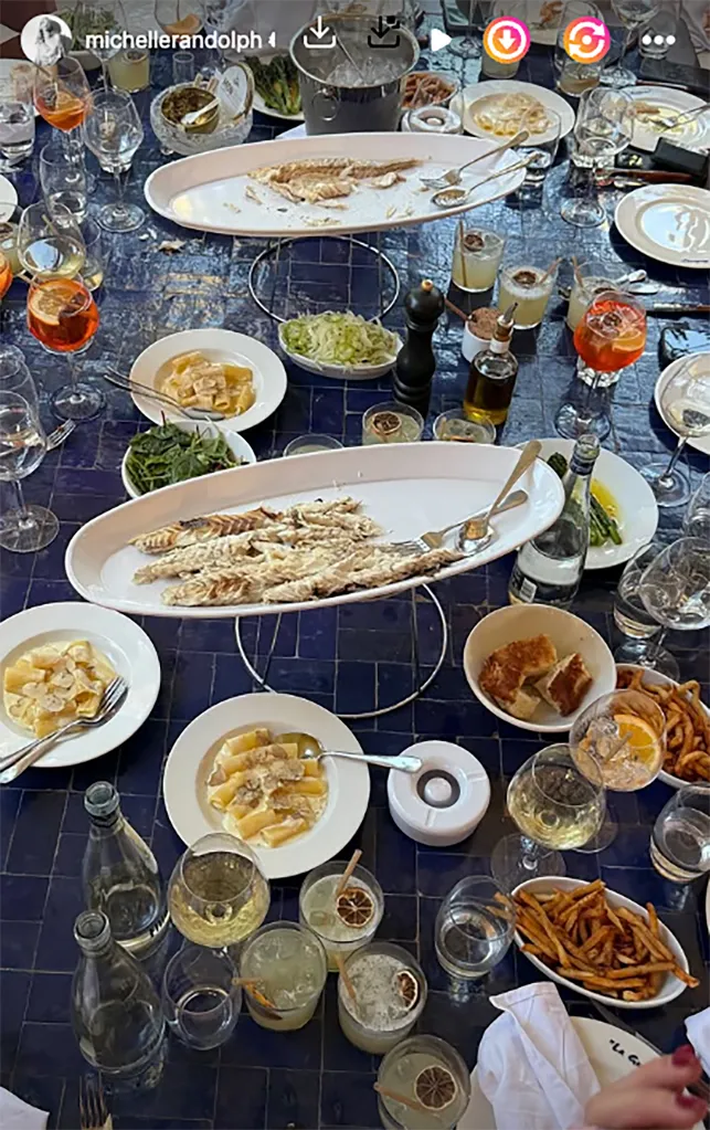 A large dining table with multiple dishes and drinks.
