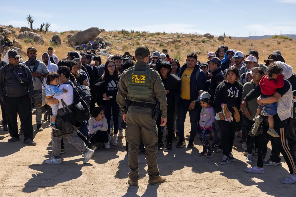 Border patrol officials stop illegal immigrants after crossing the border in California on June 10, 2024.