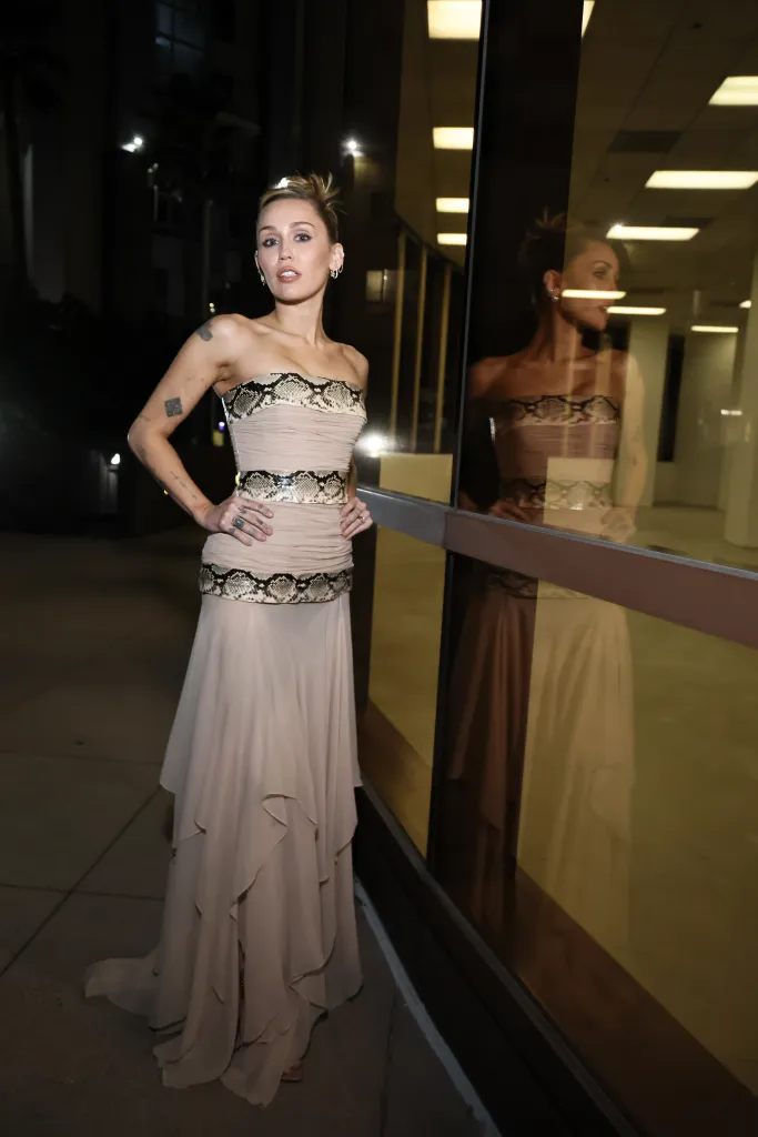 Miley Cyrus in a nude gown with a snakeskin print bodice at the 