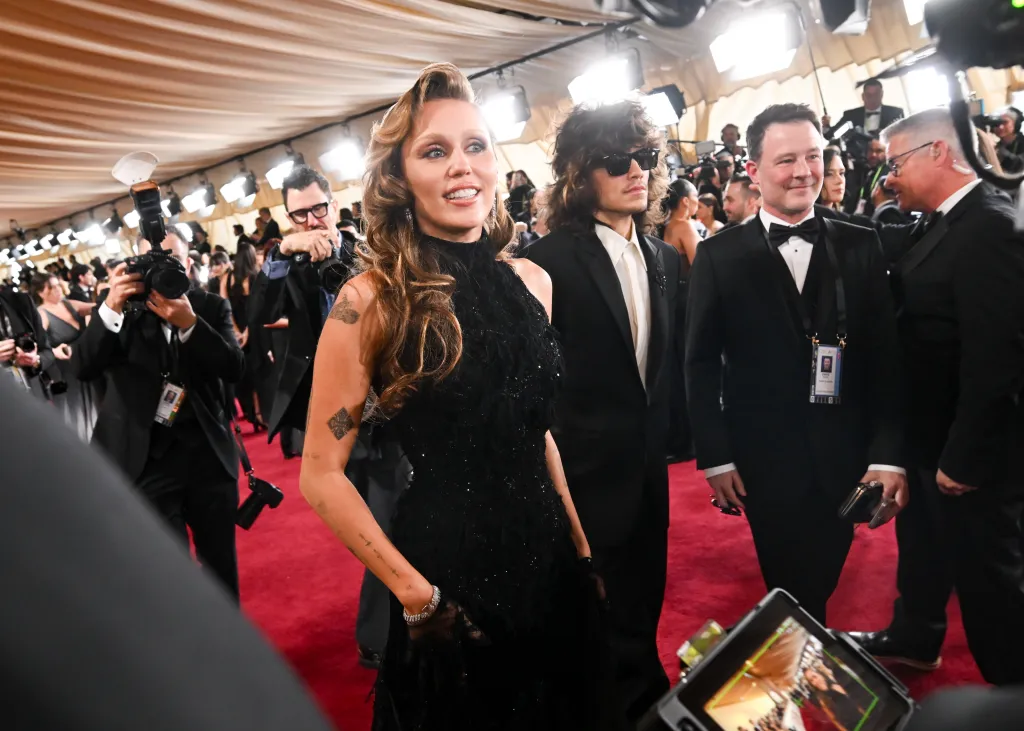 Miley Cyrus and Maxx Morando on the 97th Oscars red carpet.