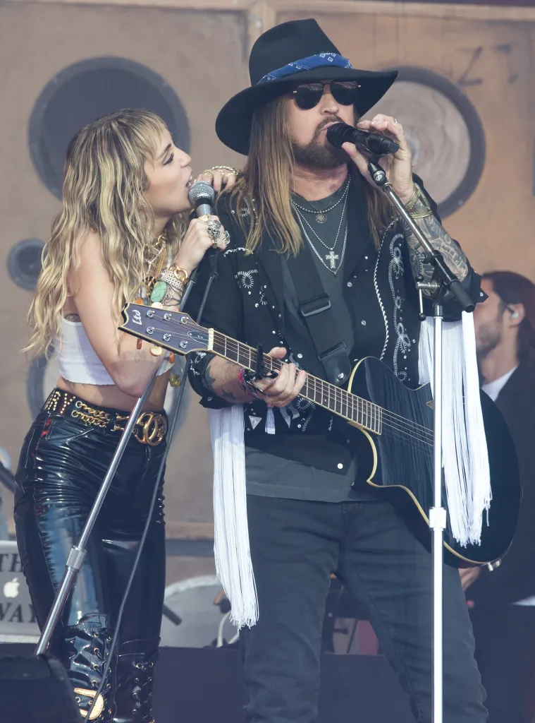 Miley Cyrus performing live with Billy Ray Cyrus at Glastonbury Festival.