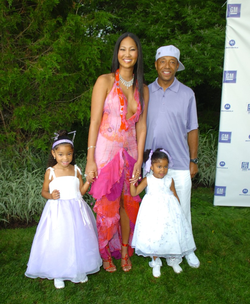 Kimora Lee Simmons, Russell Simmons, Ming Lee Simmons and Aoki Simmons pose on a grassy lawn.