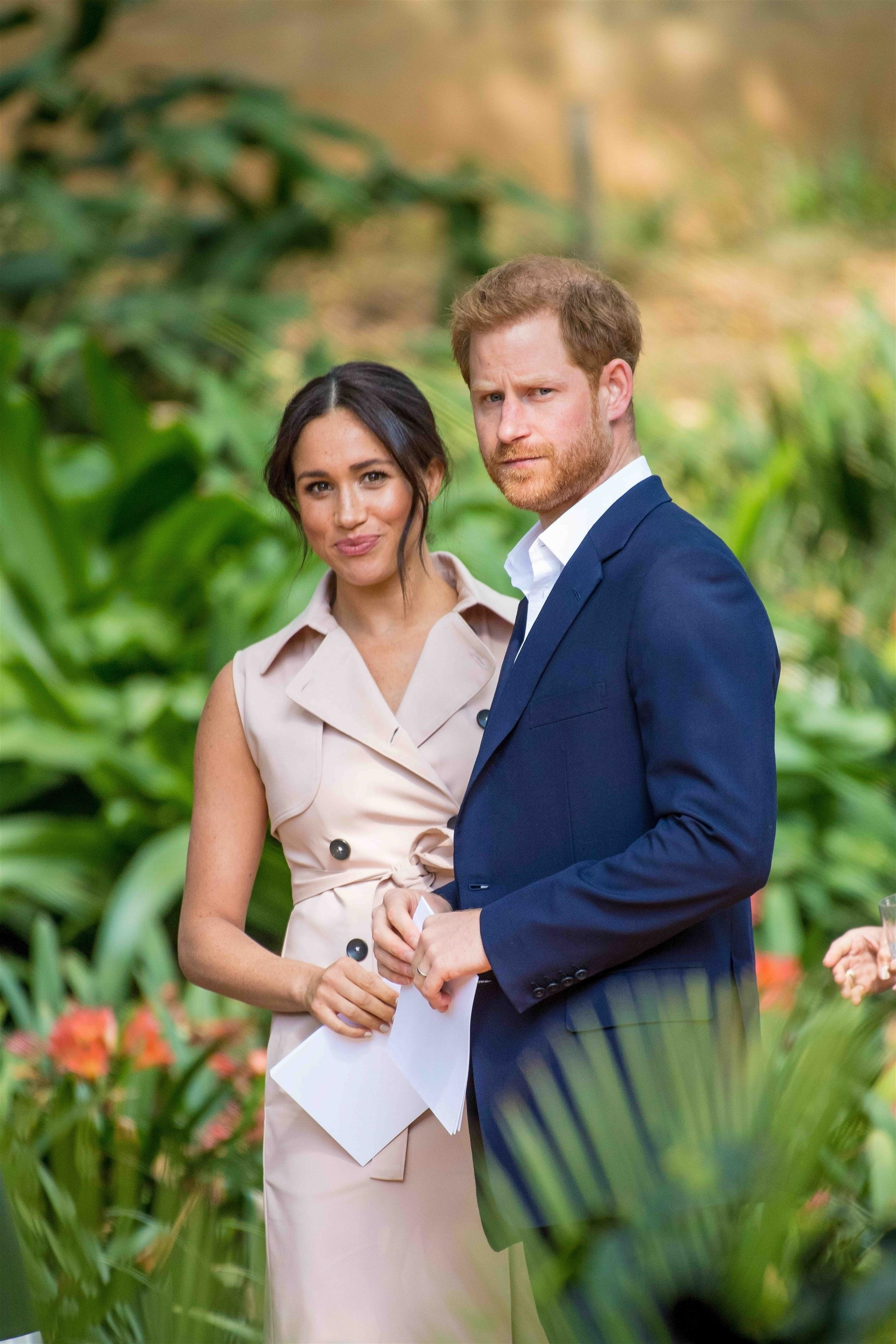 Prince Harry and Meghan Markle looking towards the camera.