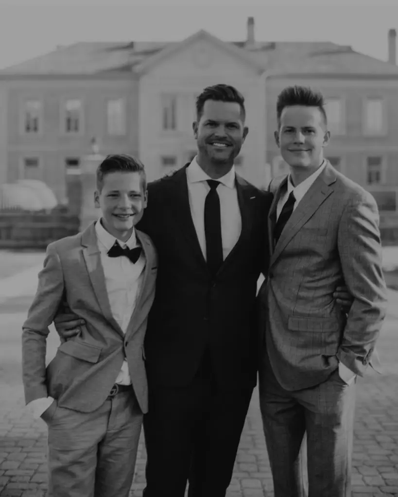 Bret Engemann with his two sons, dressed in suits.