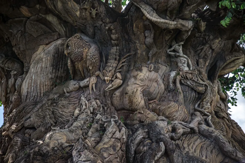 The Tree of Life sculpture with carved animals and other figures in Animal Kingdom Park at Walt Disney World.